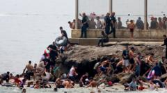 Hundreds of migrants swim from Morocco to Spanish enclave of Ceuta